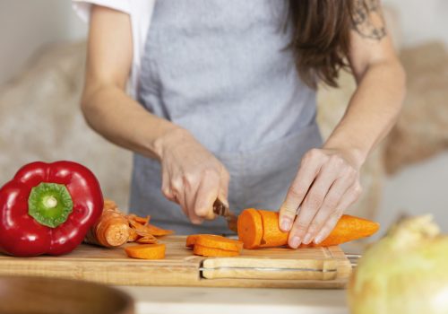 hands-cutting-carrot-close-up